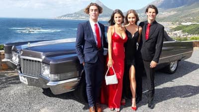 chauffeur rentals for matric balls matric dance couples standing in front of cadillac