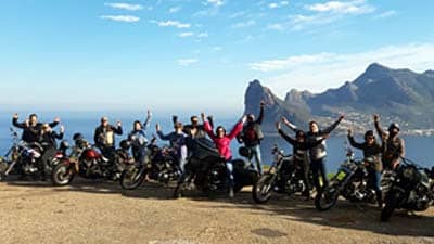 Cape corporate tours harley davidson chauffeur rides goup of people on harleys hout bay