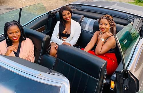 African Ladies Sitting In Convertable Cadillac