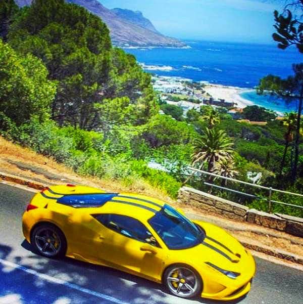 Cape Corporate Tours gallery Sports Cars Chauffeur Trips Ferrari 458 Speciale Aperta Driving On Mountain Road With View Of Cape Town Ocean