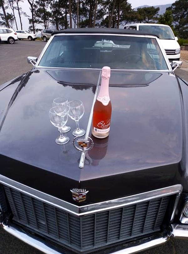 Cadillac Tours & Trips Champagne And Glasses On Car Bonnet