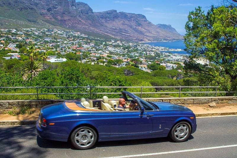 Luxury Sedan Chauffeur Trips Convertible Rolls Royce Phantom Driving On Cape Town Mountain Road Overlooking Clifton