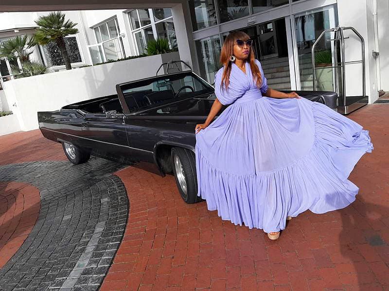 Chauffeur Rentals For Matric Balls African Lady In Purple Dress Sitting On Convertible Cadillac